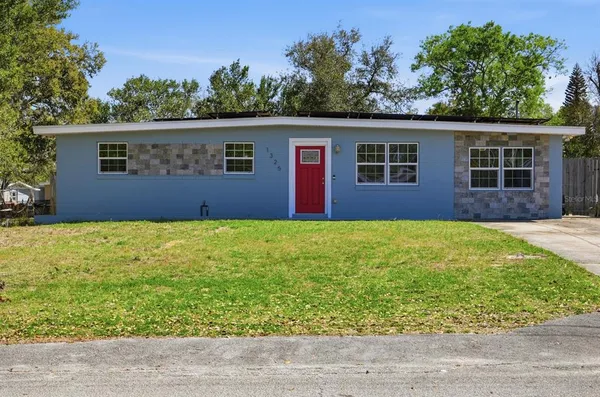 a house that has a tree in front of it