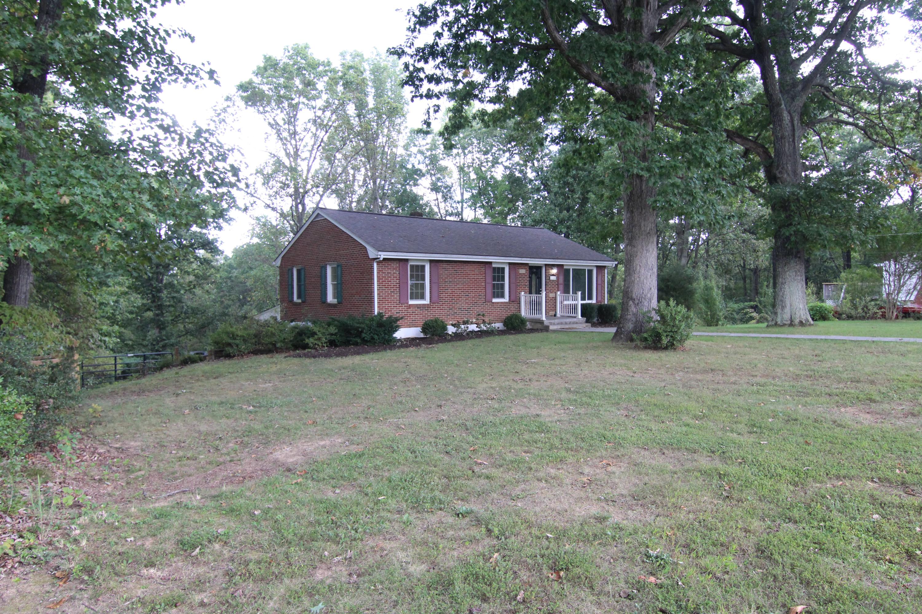 1100 Bandy Mill Road Hardy, VA 24101 - Photo 2 of 31 a front view of a house with a yard and large trees
