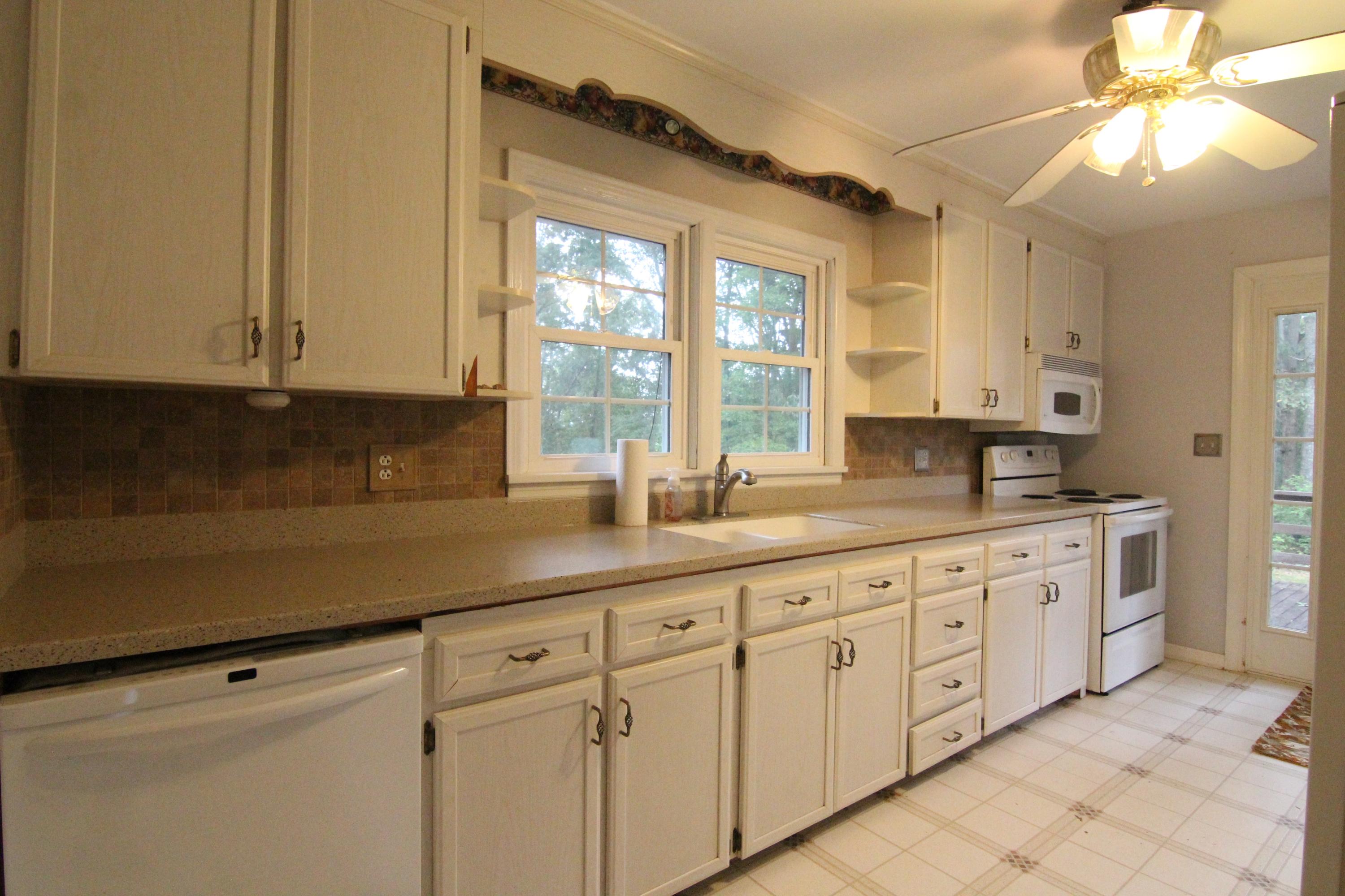 1100 Bandy Mill Road Hardy, VA 24101 - Photo 11 of 31 a kitchen with granite countertop white cabinets stainless steel appliances a sink and a window
