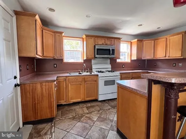 a kitchen with a sink cabinets and window