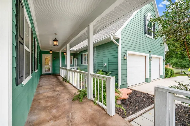 a living room with furniture a fireplace and a floor to ceiling window