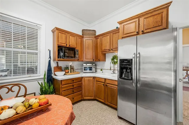 a view of a white house with a big yard and large trees