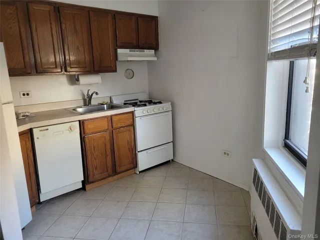 a utility room with cabinets washer and dryer