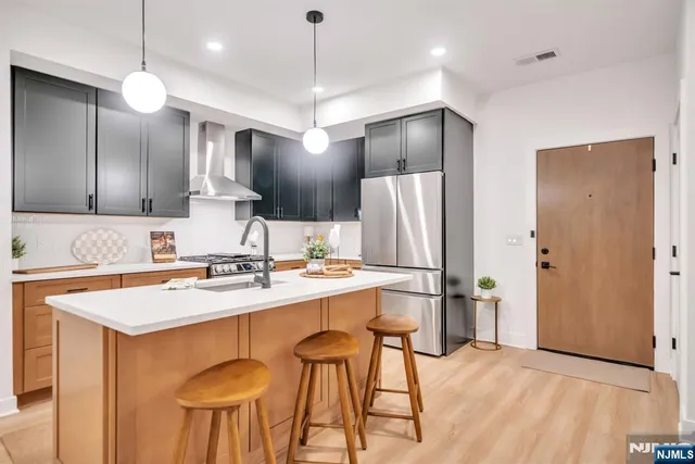 a kitchen with stainless steel appliances a refrigerator and a sink