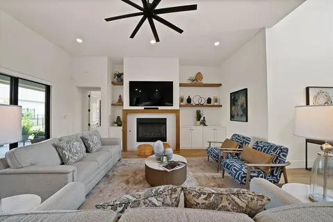 a living room with furniture and a fireplace