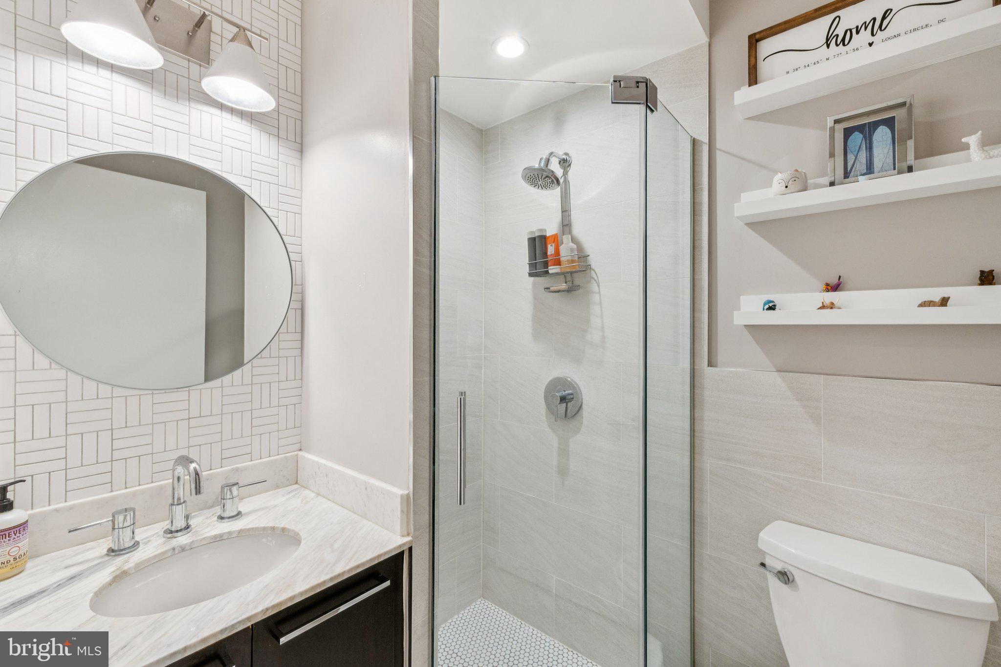1634 14th Street Northwest, Unit 201 Washington, DC 20009 - Photo 16 of 21 a bathroom with a sink a toilet and shower