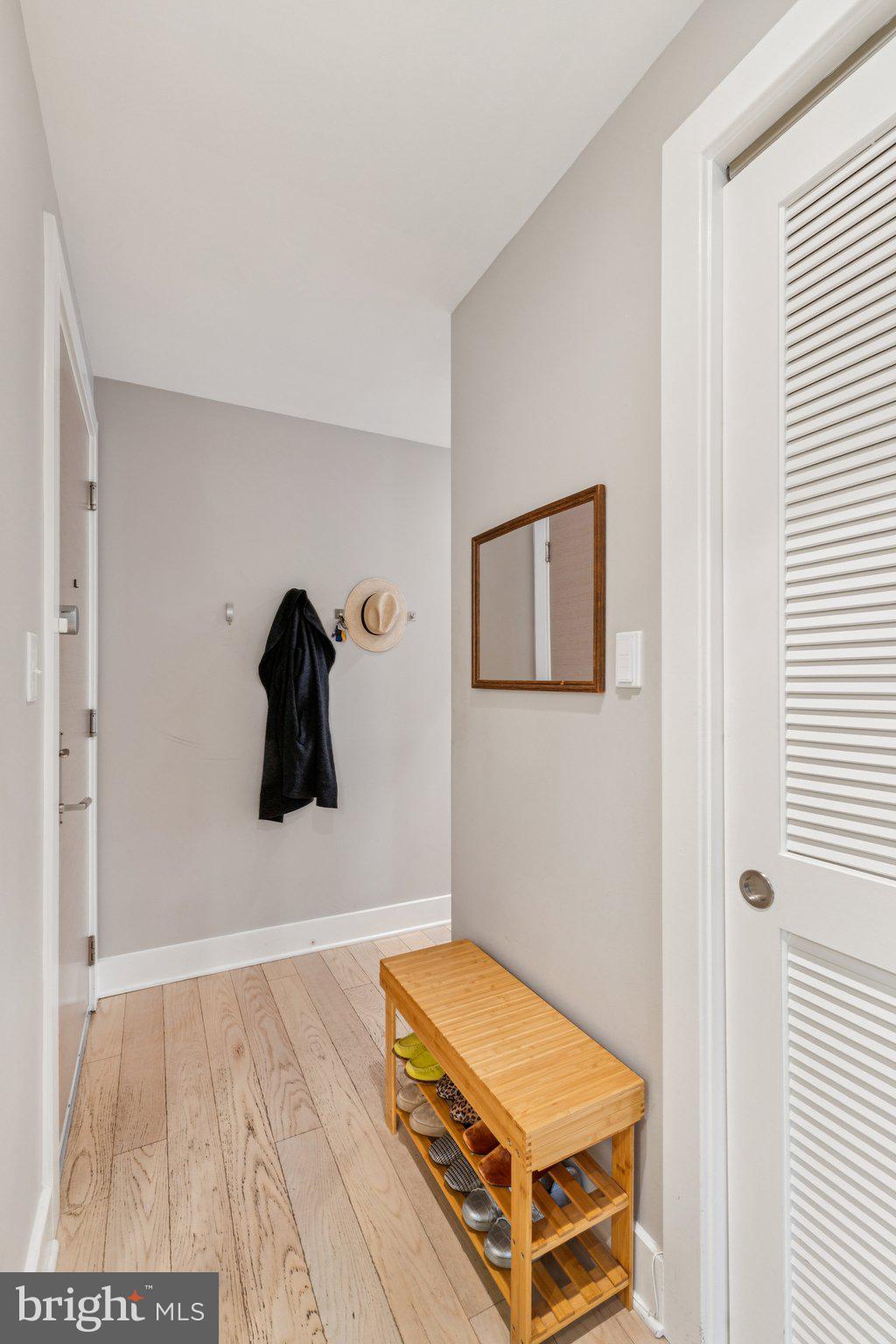 1634 14th Street Northwest, Unit 201 Washington, DC 20009 - Photo 17 of 21 a living room with a baby bed and a painting on the wall