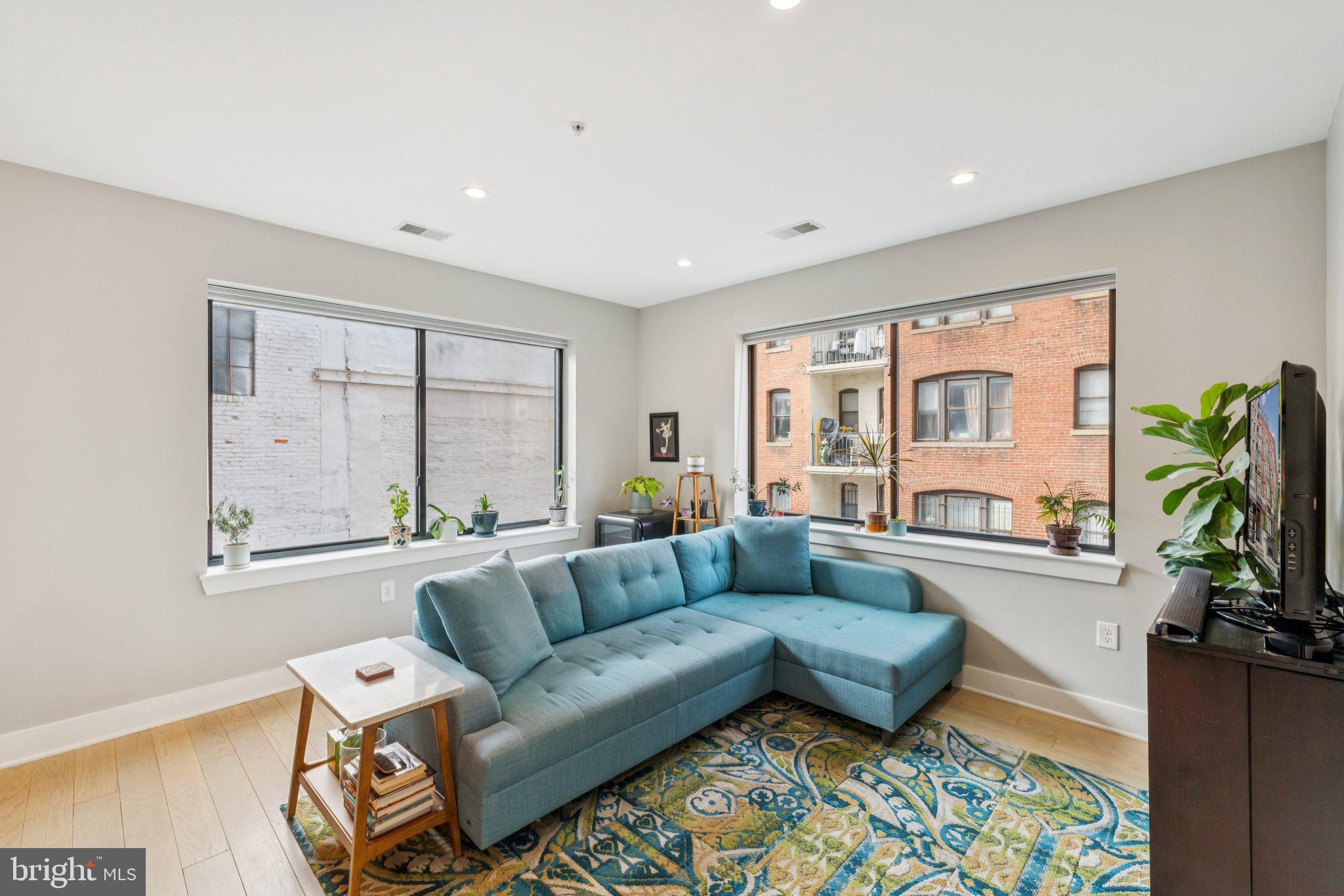 1634 14th Street Northwest, Unit 201 Washington, DC 20009 - Photo 2 of 21 a living room with furniture and a large window