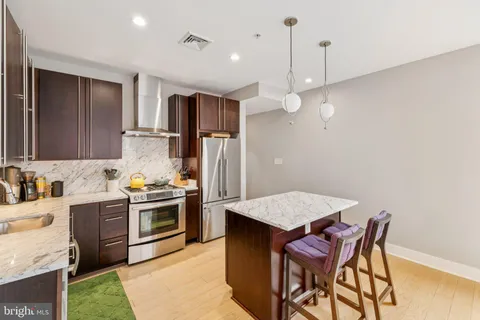 a kitchen with a stove a refrigerator and a sink