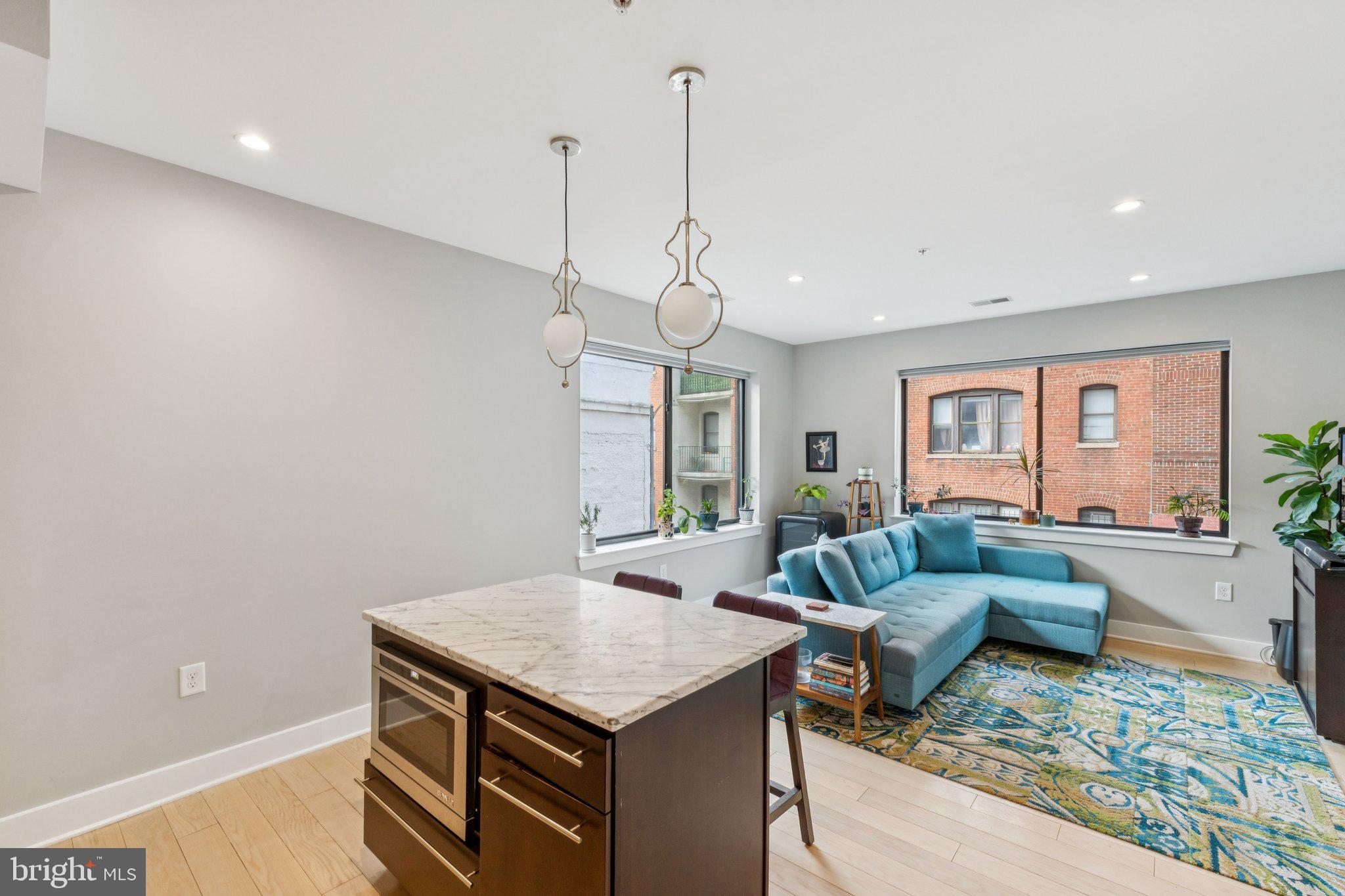1634 14th Street Northwest, Unit 201 Washington, DC 20009 - Photo 8 of 21 a living room with furniture and a chandelier