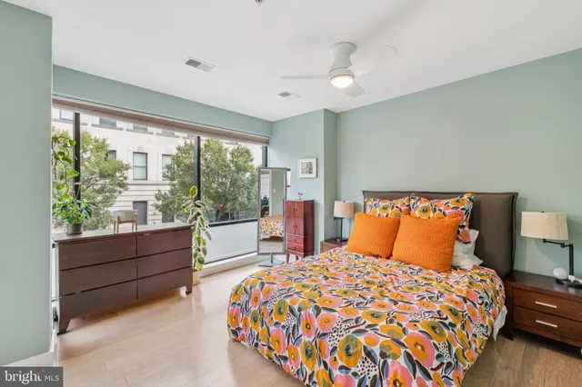 a bedroom with a large bed and a large window