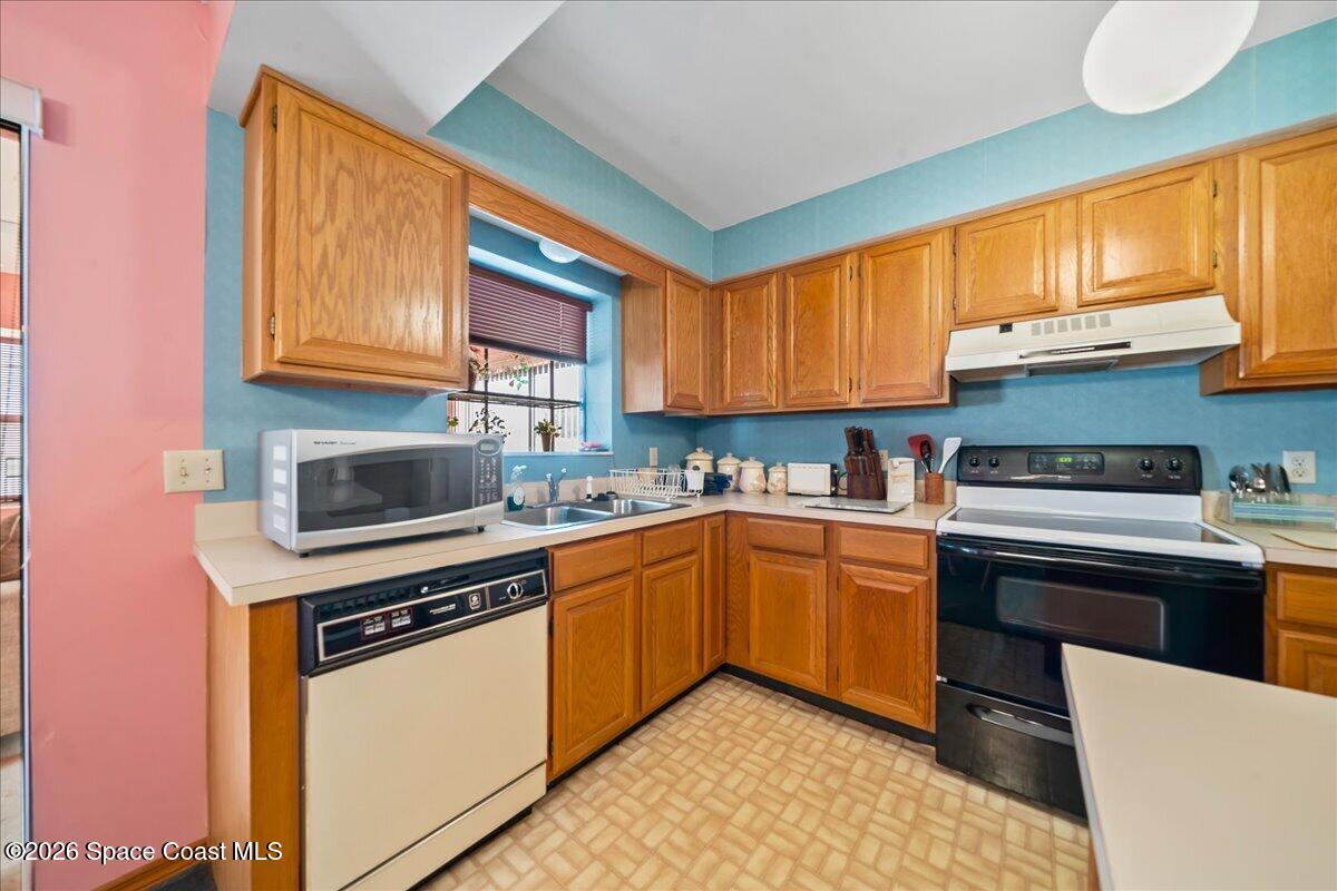 846 Gardener Road Rockledge, FL 32955 - Photo 13 of 27 a kitchen with stainless steel appliances granite countertop a stove sink and cabinets