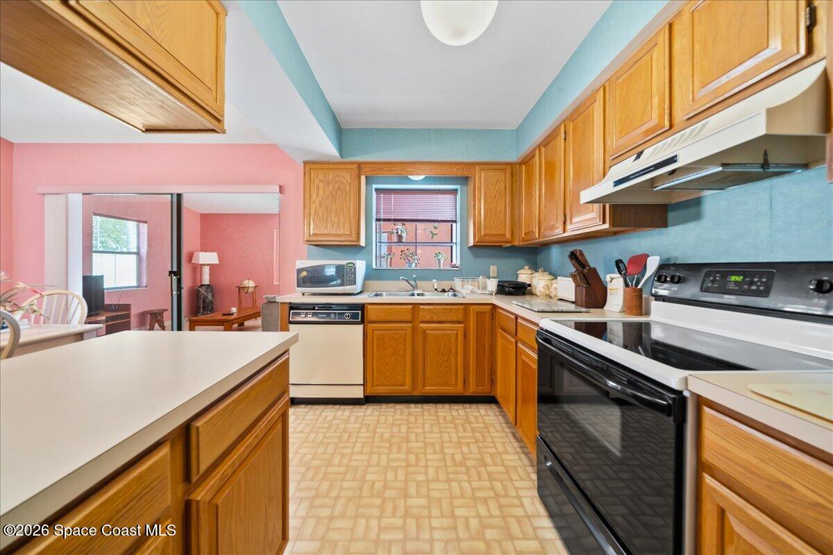 846 Gardener Road Rockledge, FL 32955 - Photo 14 of 27 a kitchen with stainless steel appliances granite countertop a sink and cabinets