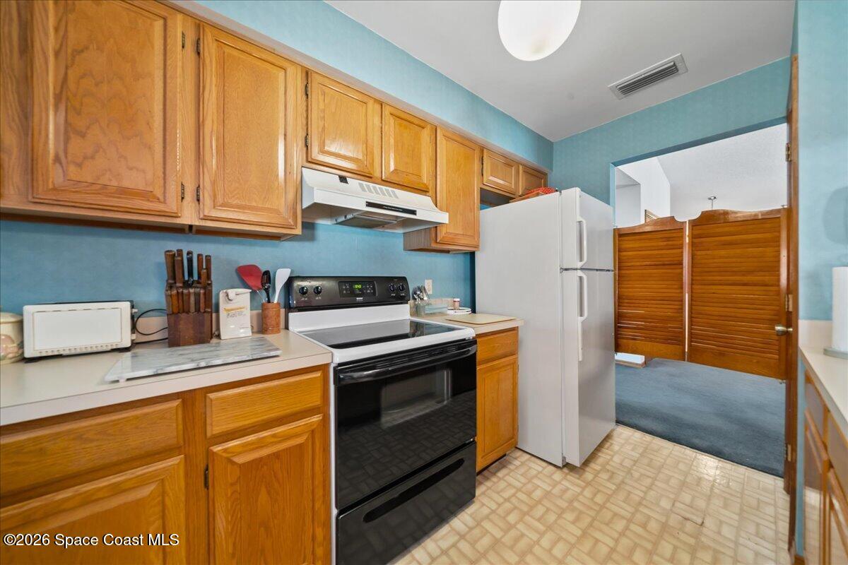 846 Gardener Road Rockledge, FL 32955 - Photo 15 of 27 a kitchen with stainless steel appliances granite countertop a refrigerator sink and cabinets