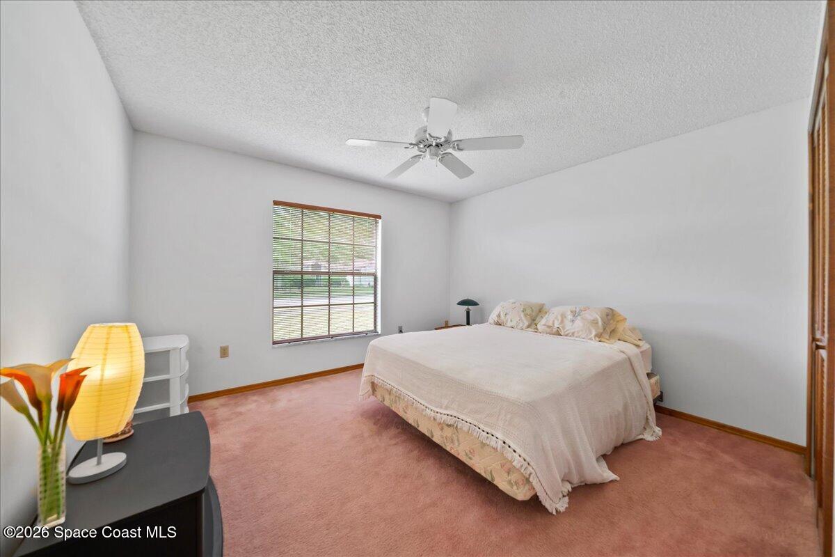 846 Gardener Road Rockledge, FL 32955 - Photo 20 of 27 a bed sitting in a spacious bedroom next to a window