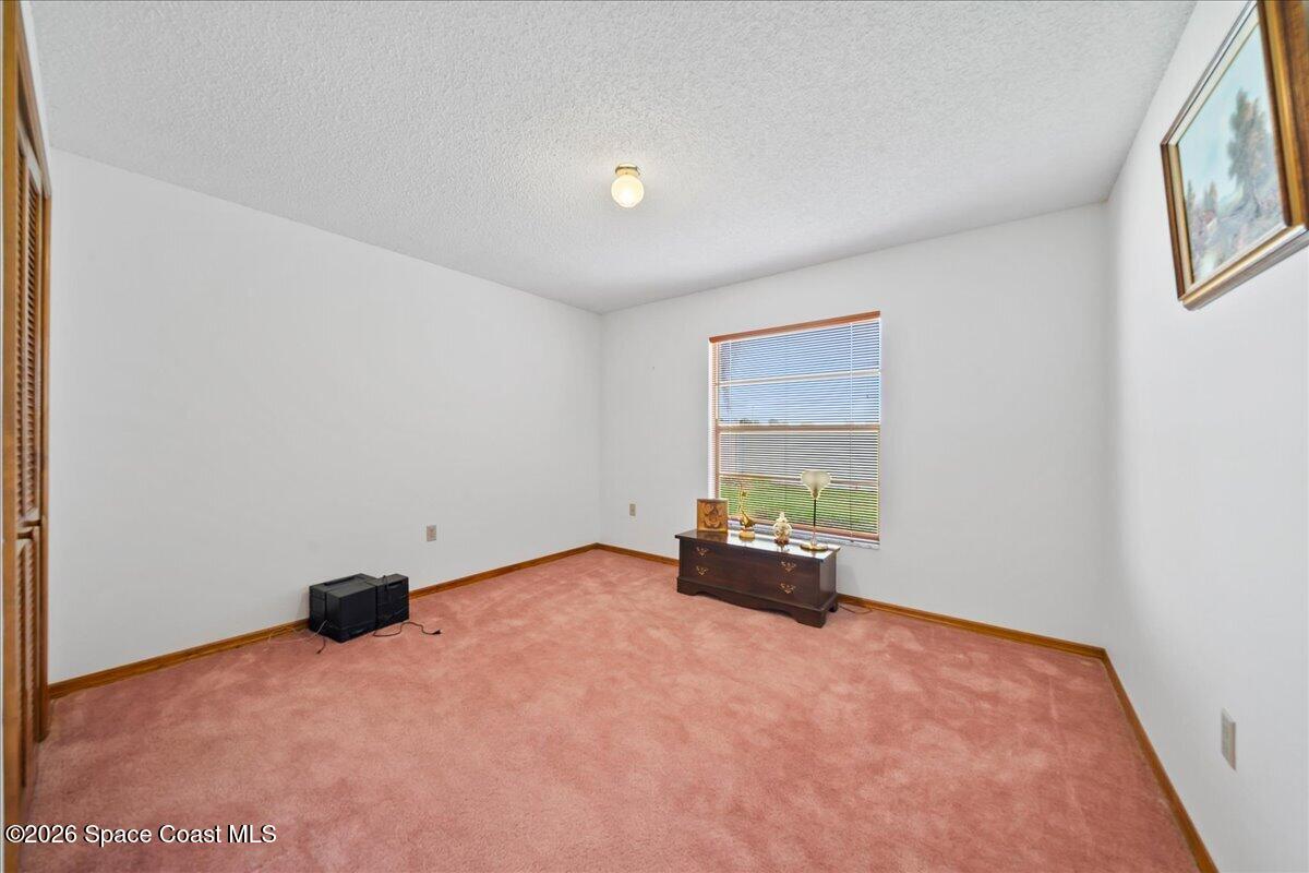 846 Gardener Road Rockledge, FL 32955 - Photo 21 of 27 an empty room with a window