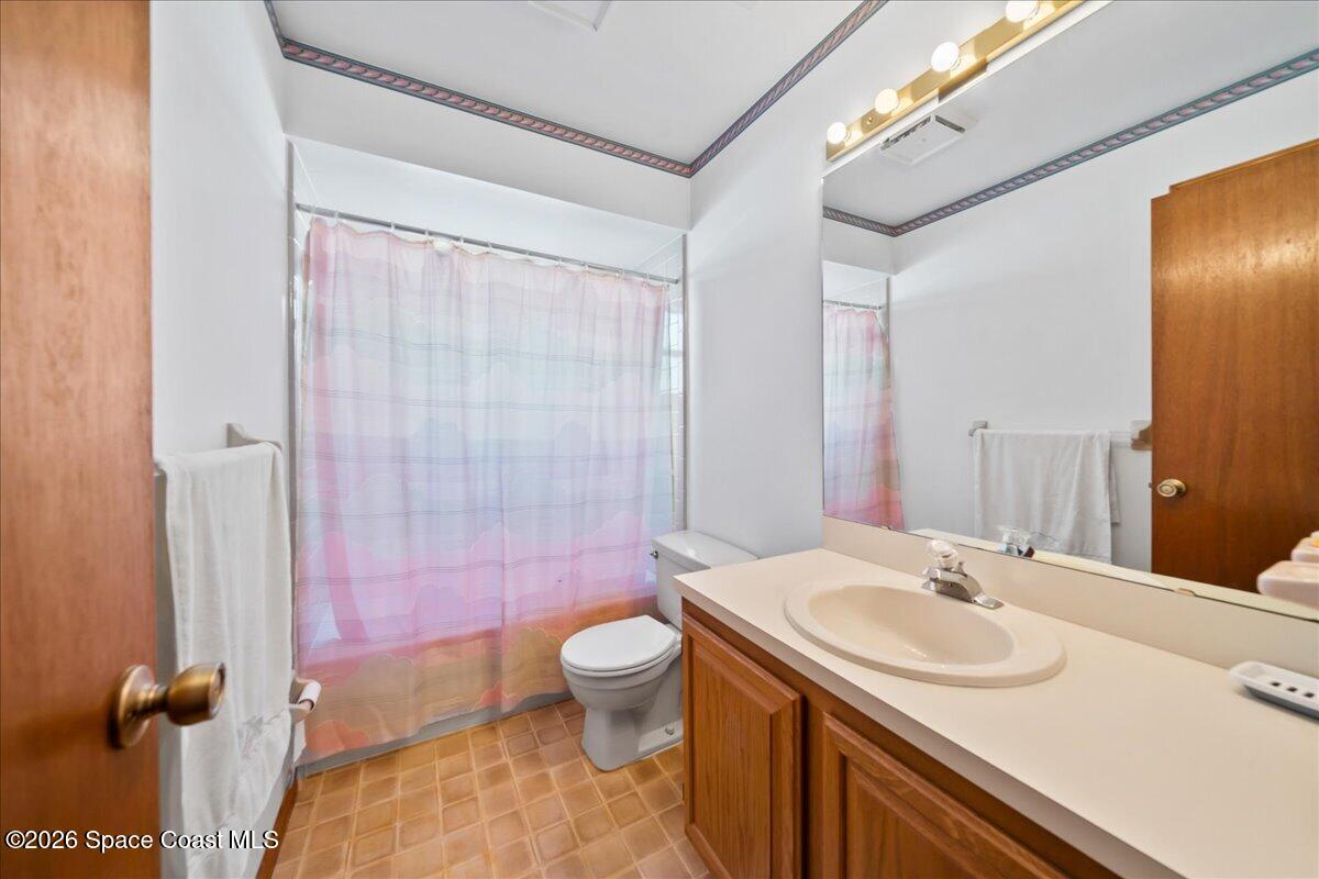 846 Gardener Road Rockledge, FL 32955 - Photo 22 of 27 a bathroom with a sink a toilet a mirror and shower