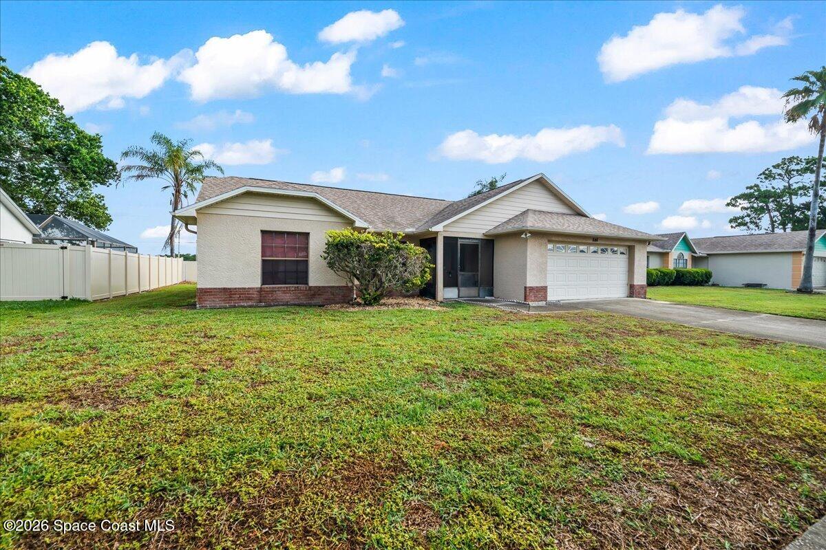 846 Gardener Road Rockledge, FL 32955 - Photo 3 of 27 a front view of a house with garden