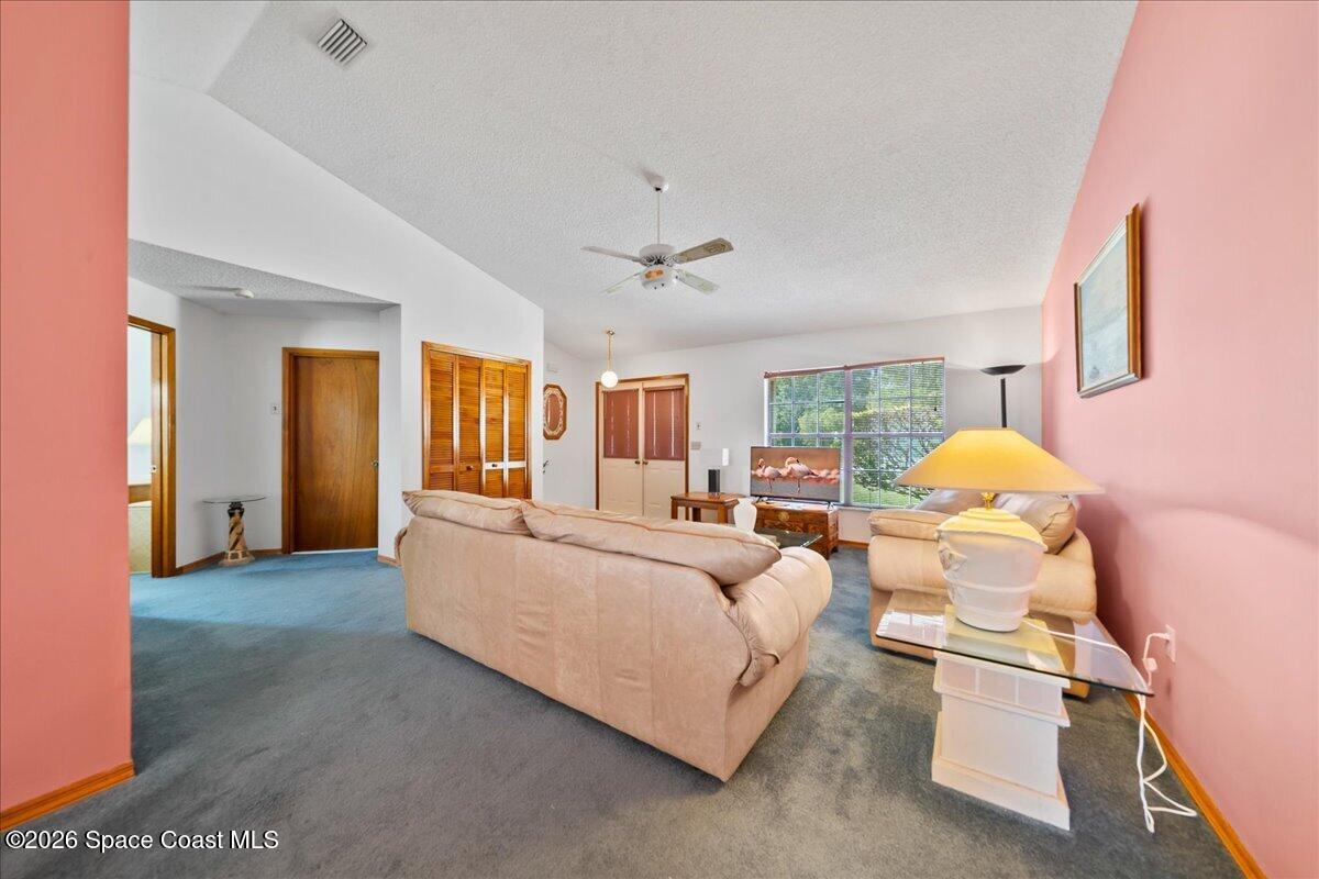 846 Gardener Road Rockledge, FL 32955 - Photo 6 of 27 a living room with furniture and a chandelier