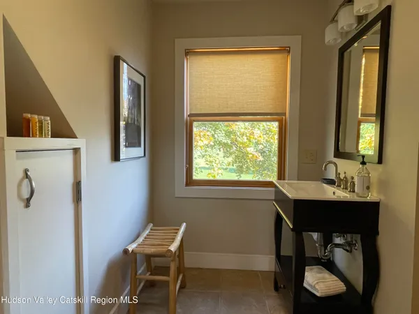 a view of a workspace with furniture and a window