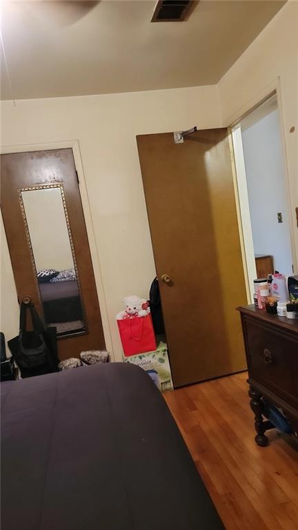 234 Howell Terrace Southwest Atlanta, GA 30331 - Photo 16 of 64 a bedroom with a bed and wooden floor