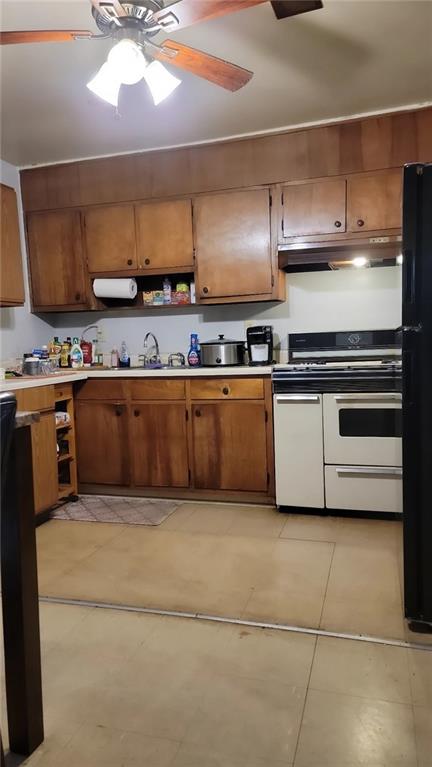 234 Howell Terrace Southwest Atlanta, GA 30331 - Photo 33 of 64 a kitchen with stainless steel appliances a stove a sink and a refrigerator
