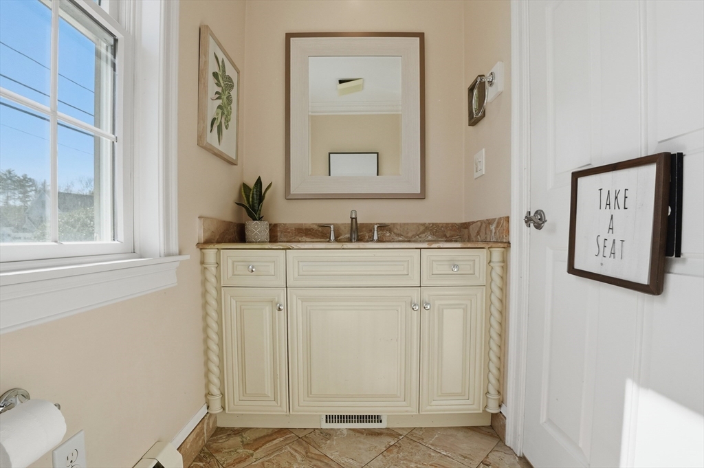 183 Whiting Street Hanover, MA 02339 - Photo 31 of 42 a bathroom with a sink and a mirror