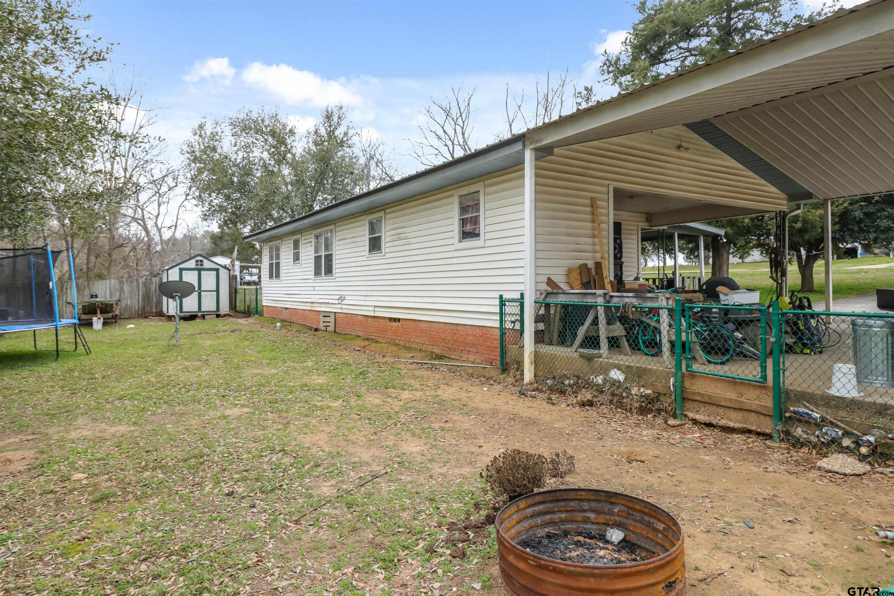 1499 Farm To Market 23 Rusk, TX 75785 - Photo 4 of 15 a backyard of a house with barbeque oven table and chairs