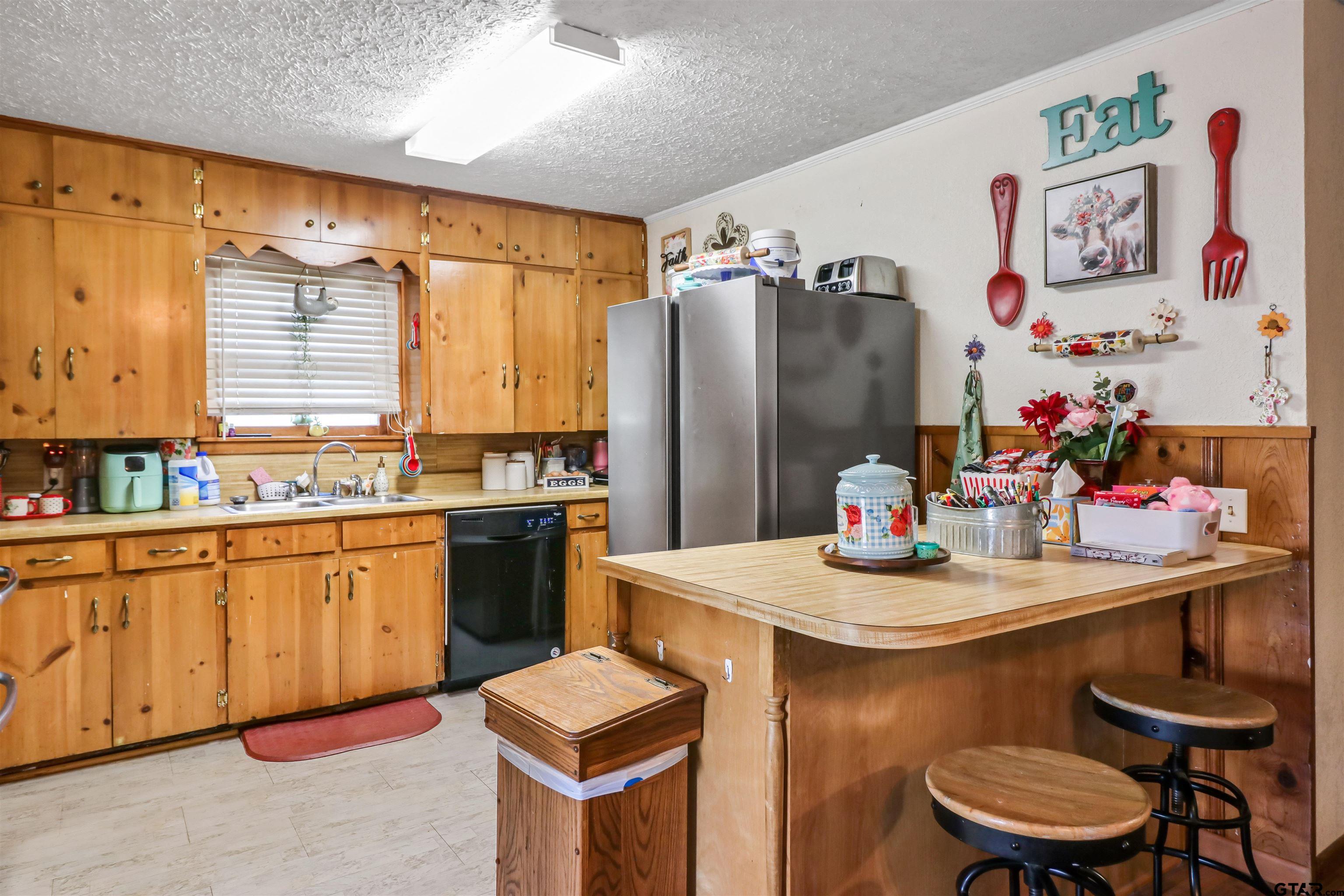 1499 Farm To Market 23 Rusk, TX 75785 - Photo 8 of 15 a kitchen with stainless steel appliances kitchen island granite countertop a sink dishwasher and cabinets with wooden floor