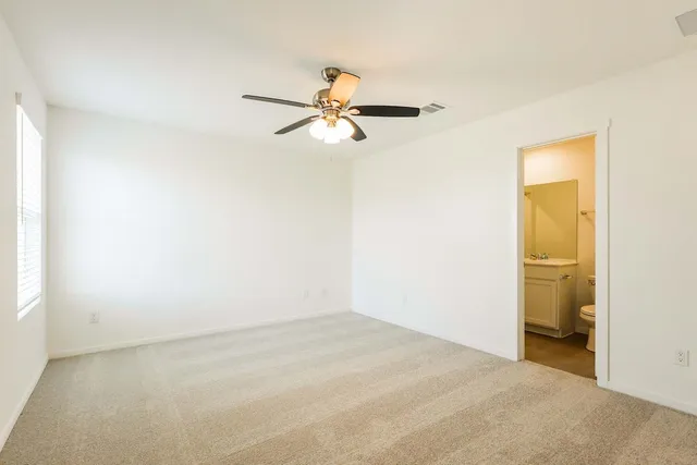 a view of a room with a ceiling fan and closet