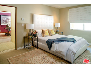 2000 Old Ranch Road Los Angeles, CA 90049 - Photo 17 of 30 a bedroom with a bed and a painting on the wall