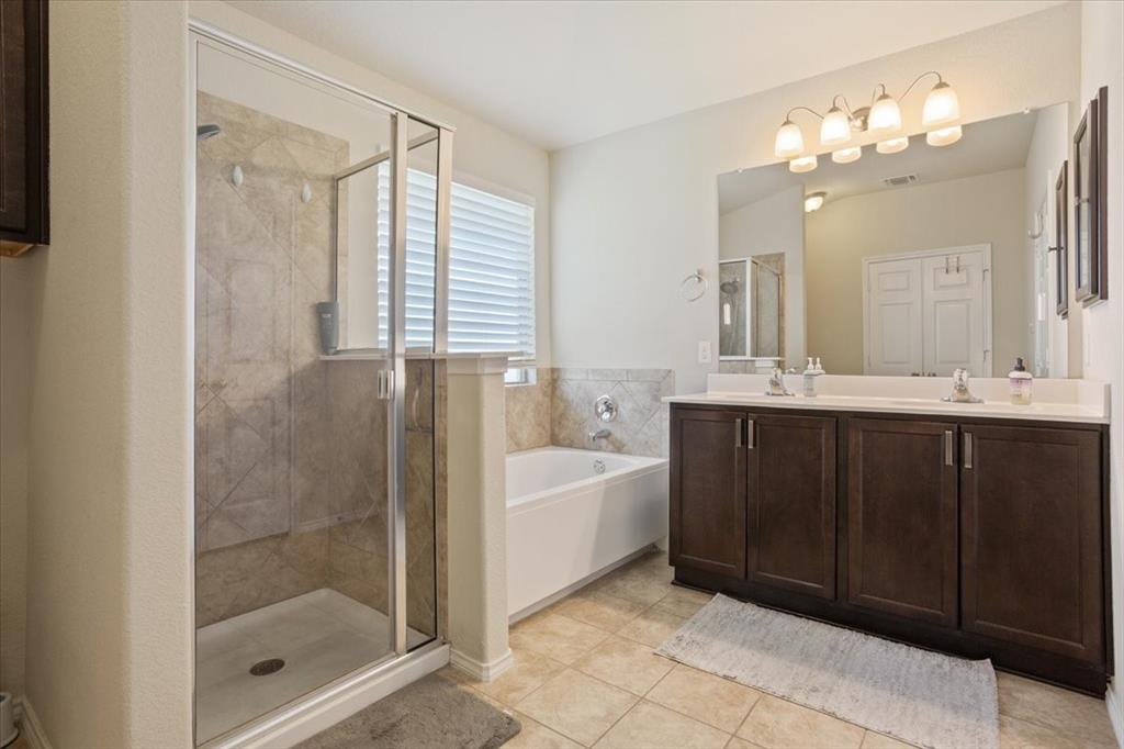 5308 Tama Drive Waco, TX 76708 - Photo 19 of 29 a bathroom with a bathtub shower sink mirror and