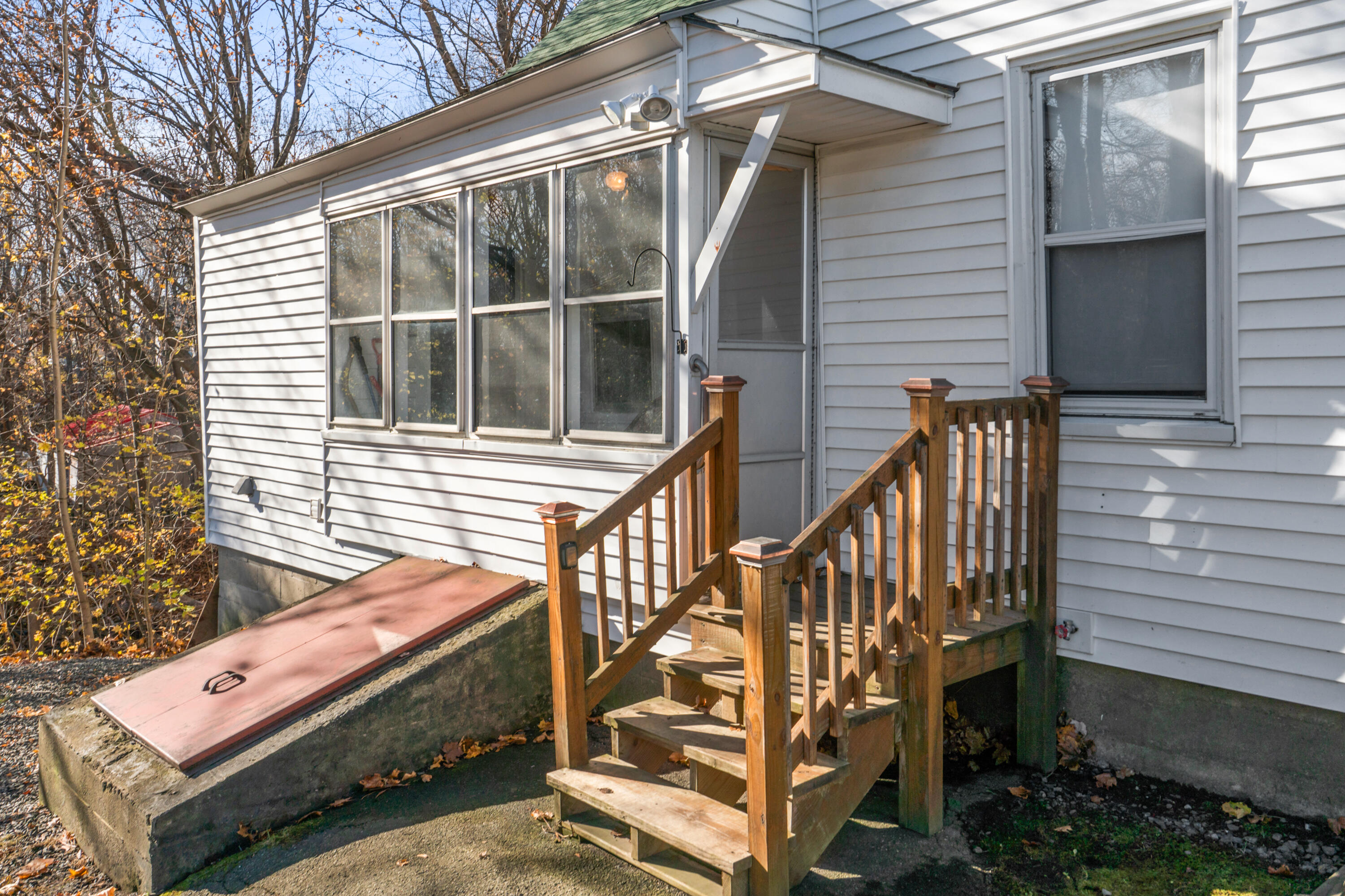70 Spring Street Gardiner, ME 04345 - Photo 4 of 35 Side sun room and bulkhead door