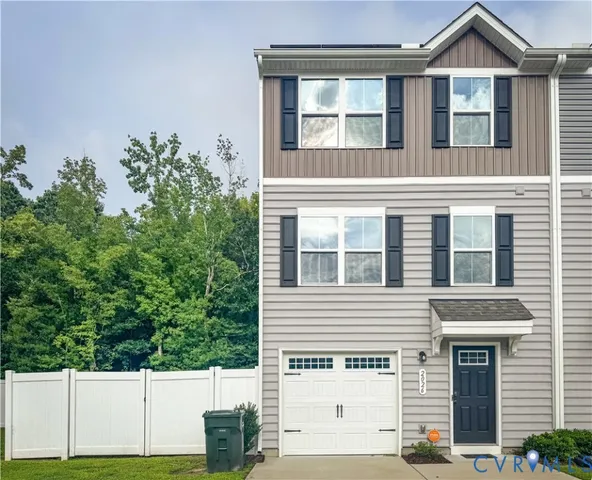 a view of a house with potted plants and a yard