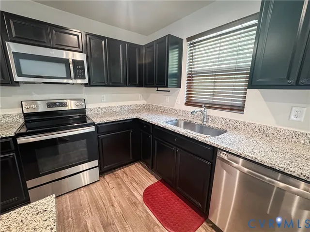 a view of a room with wooden floor and staircase