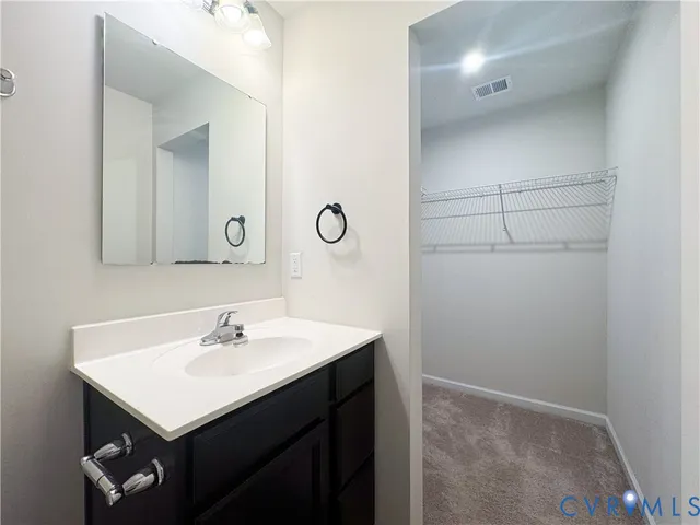 a bathroom with a sink mirror toilet and bathtub