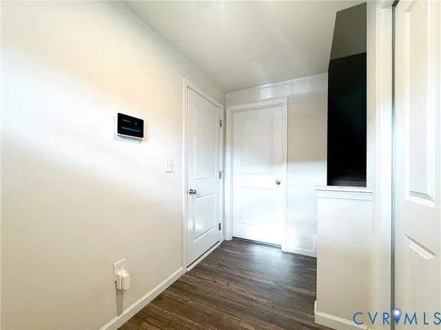 a view of a hallway with wooden floor