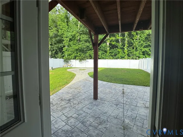 a view of yard with swimming pool and trees in the background