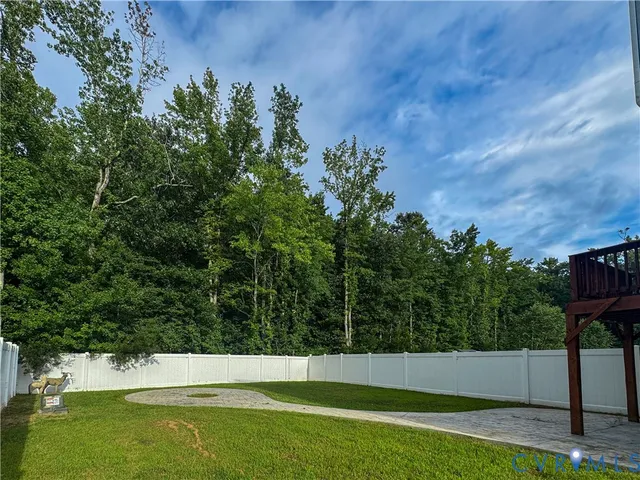 a view of a house with a backyard and a small yard