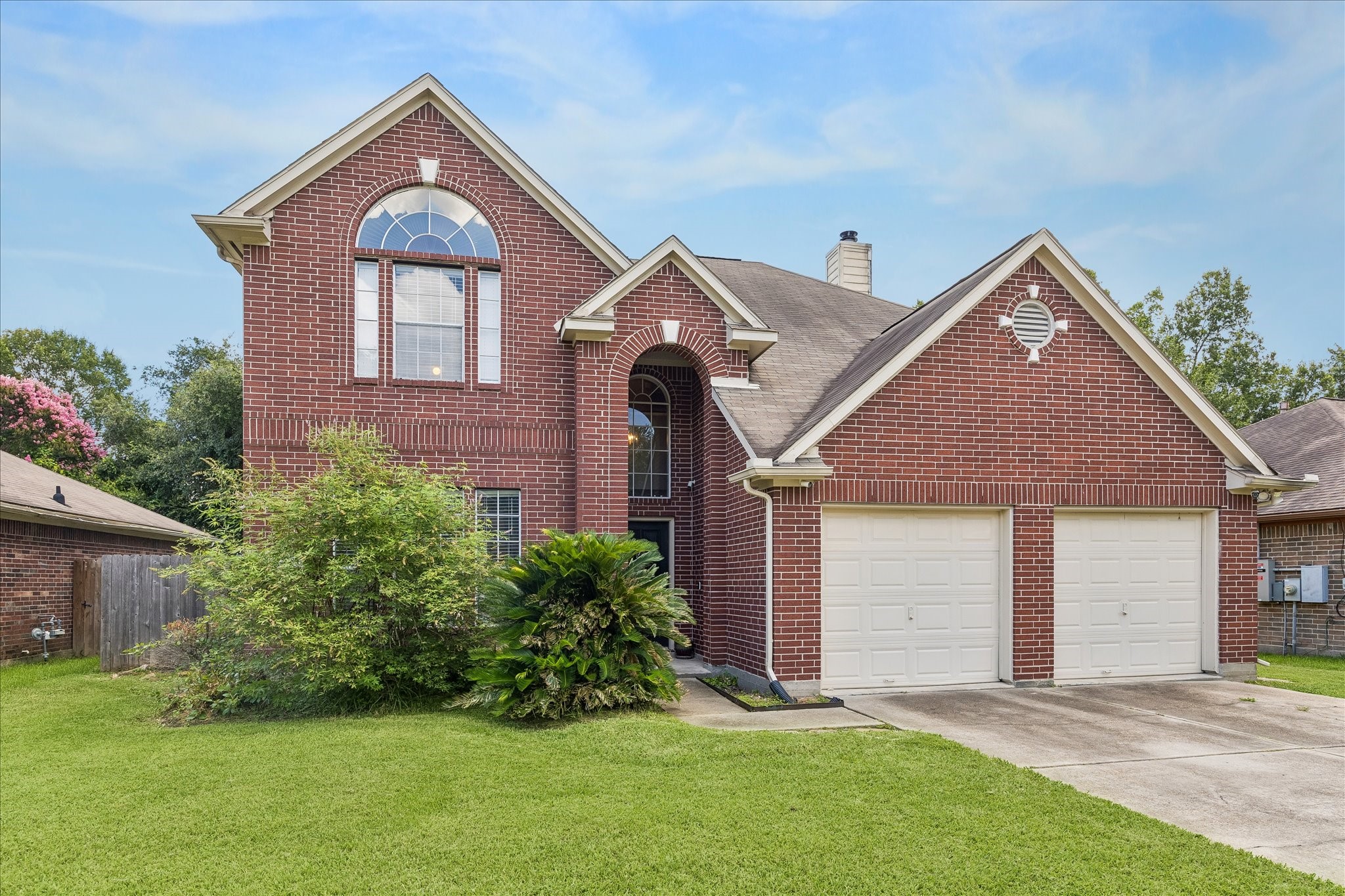 23234 Grand Rapids Lane Spring, TX 77373 - Photo 30 of 30 Elegant brick two-story residence with dramatic arched window and lush landscaping offers timeless curb appeal.