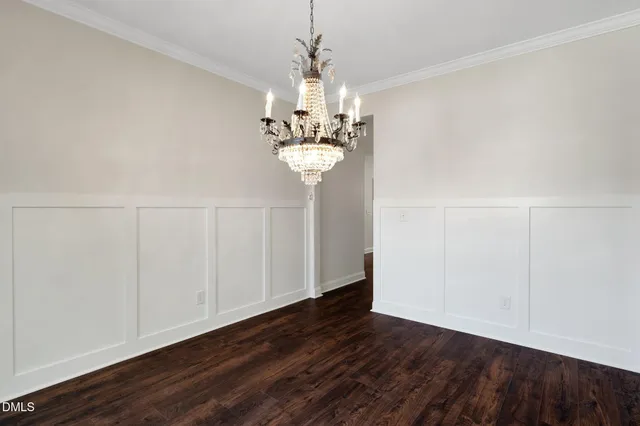 a view of a chandelier in big room and wooden floor