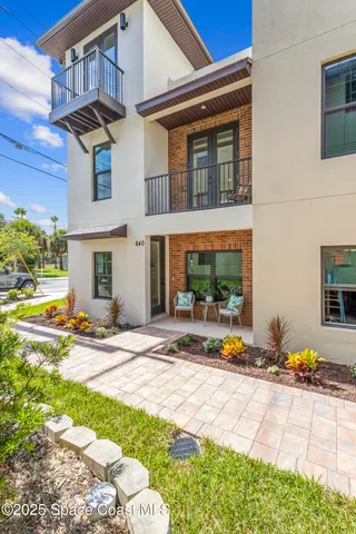 a view of a house with backyard and sitting area