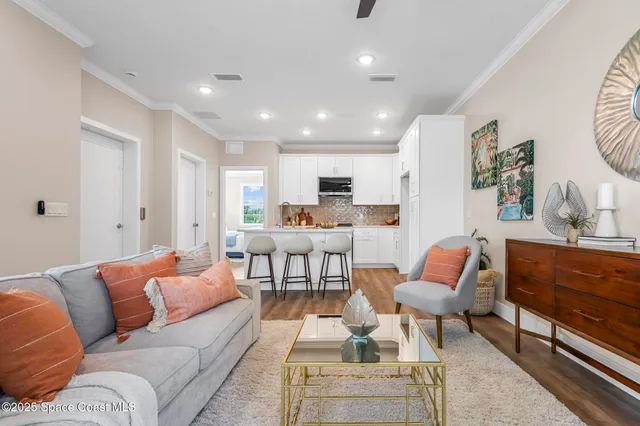 a living room with furniture wooden floor and a window