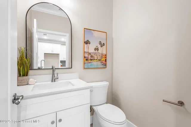 a bathroom with a sink mirror vanity and toilet