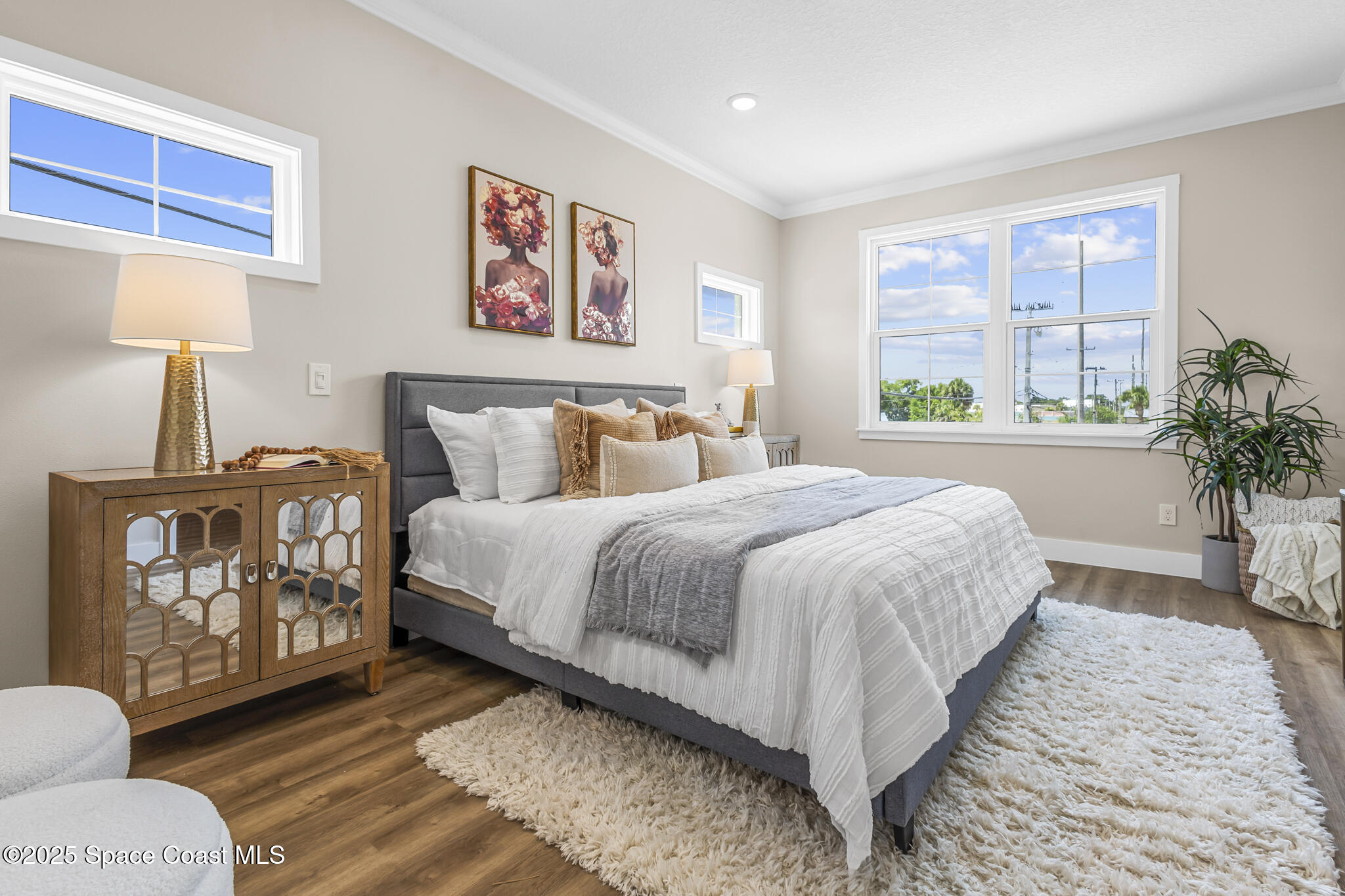 840 Florida Avenue, Unit 5 Cocoa, FL 32922 - Photo 22 of 31 a spacious bedroom with a bed a dresser and next to a window