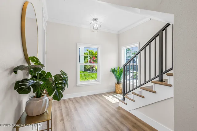 a view of an entryway with wooden floor