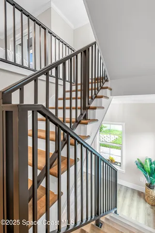 a view of staircase with railing and stairs