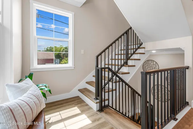 a living room with furniture and stairs
