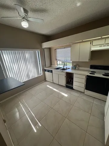 a kitchen with stainless steel appliances a stove sink and cabinets