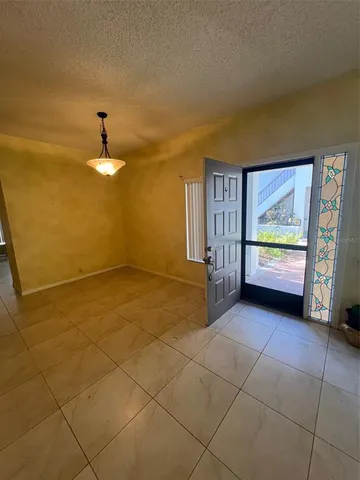 a view of hallway with stairs and furniture